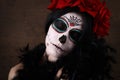 Day of the dead. Halloween. Young woman in day of the dead mask skull face art and rose. Dark background. Royalty Free Stock Photo