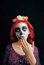 A young woman in day of the dead mask skull face art. Royalty Free Stock Photo