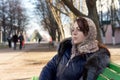 Young woman daydreaming on a park bench Royalty Free Stock Photo