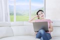 Young woman daydreaming on sofa Royalty Free Stock Photo