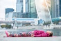 Young woman in Dead Body pose against the skyscraper Royalty Free Stock Photo