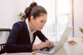 Young woman deep in thought in front of a laptop Royalty Free Stock Photo