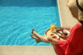 Young woman with delicious breakfast on tray near swimming pool, closeup. Space for text Royalty Free Stock Photo