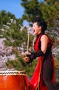 A young woman demonstrates the ancient art of Japanese Taiko drumming
