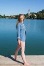Young Woman in Denim Shirt Standing on Lake Dock Royalty Free Stock Photo