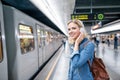 Young woman in denim shirt at the underground platform, waiting Royalty Free Stock Photo