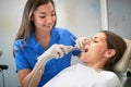Young woman during the dental procedure with dentist Royalty Free Stock Photo