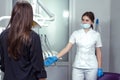 Young woman dentist welcoming female patient