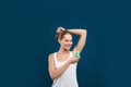 Young woman  deodorant to armpit on blue background Royalty Free Stock Photo