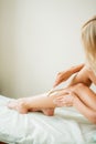 Young woman waxing her lower leg with honey Royalty Free Stock Photo