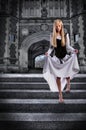 Young Woman Descending Steps of Castle Royalty Free Stock Photo