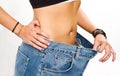 young woman after diet with big jeans
