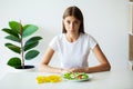 Young woman on a diet, eats only salad and tries to lose weight Royalty Free Stock Photo