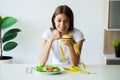 Young woman on a diet, eats only salad and tries to lose weight Royalty Free Stock Photo