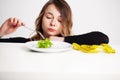 Young woman on a diet, eats only salad and tries to lose weight Royalty Free Stock Photo