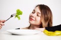Young woman on a diet, eats only salad and tries to lose weight Royalty Free Stock Photo
