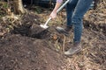 Young woman digging hole in garden Royalty Free Stock Photo