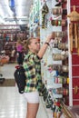 Young woman disappointed with the choice of ornamentals. Shopping and gifts concept.