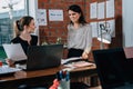 Young woman discussing plans with colleague in her office Royalty Free Stock Photo