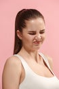 Young woman with disgusted expression repulsing something, on the pink Royalty Free Stock Photo