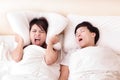 Young woman disturbed by the snores of her husband