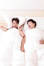 Young woman disturbed by the snores of her husband Royalty Free Stock Photo