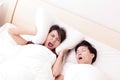 Young woman disturbed by the snores of her husband Royalty Free Stock Photo