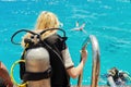 Young woman diver preparing for scuba diving