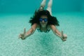 Young woman diving underwater in a pool. summer and fun lifestyle Royalty Free Stock Photo