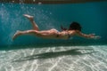 Young woman diving underwater in a pool. summer and fun lifestyle Royalty Free Stock Photo