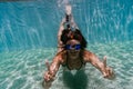 Young woman diving underwater in a pool. summer and fun lifestyle Royalty Free Stock Photo