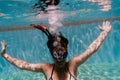 Young woman diving underwater in a pool. summer and fun lifestyle Royalty Free Stock Photo