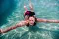 Young woman diving underwater in a pool. summer and fun lifestyle Royalty Free Stock Photo