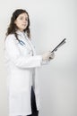 Young woman doctor, holding a folder. looking at camera Royalty Free Stock Photo