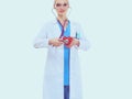 Young woman doctor holding a red heart, isolated on white background. Woman doctor Royalty Free Stock Photo