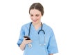 Young woman doctor looking at her smartphone Royalty Free Stock Photo