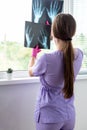 Young woman doctor looking at xray radiography images at clinic. Physician, surgeon reviewing scan of patient bones