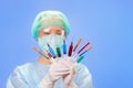 Young woman doctor with many multicolor syringes