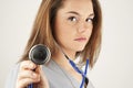 Young woman doctor or nurse holding a stethoscope Royalty Free Stock Photo