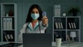 Young woman doctor nurse in protective mask measuring temperature with non-contact infrared thermometer digital Royalty Free Stock Photo