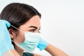 Young woman doctor portrait wearing surgical face mask and gloves - People working for preventing and stop corona virus spread