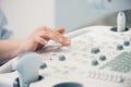 Young woman doctor`s hands close up preparing for an ultrasound device scan.