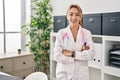 Young woman doctor smiling confident standing with arms crossed gesture at clinic Royalty Free Stock Photo