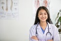 Young woman doctor smiling and working at office Royalty Free Stock Photo