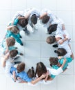 Young woman doctor standing in front of her happy colleagues Royalty Free Stock Photo