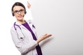 Young woman doctor with stethoscope and headphones with a blank billboard in white uniform on white background Royalty Free Stock Photo