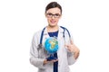 Young woman doctor with stethoscope holding a world globe in her hands in white uniform on white background Royalty Free Stock Photo