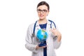 Young woman doctor with stethoscope holding a world globe in her hands in white uniform on white background Royalty Free Stock Photo