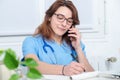 Young woman doctor talking on the phone Royalty Free Stock Photo