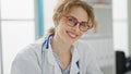 Young woman doctor wearing glasses smiling at the clinic Royalty Free Stock Photo